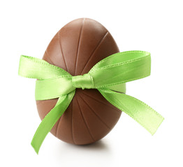 Chocolate Easter egg with color ribbon bow isolated on white
