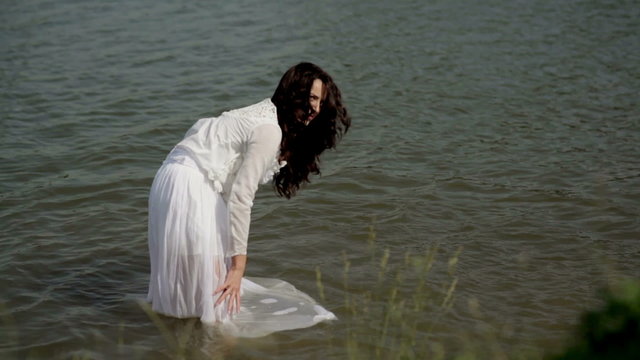 Girl dabbles in the river