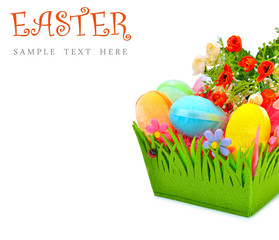 Easter colored cloth eggs, roses in the flowerbed.