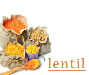 green, red and yellow lentils in the sacks and spoon wooden isol