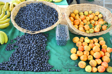 Harvest of fresh acai berries and apricots