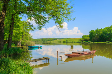 Obraz premium Boat on lake in countryside landscape in spring, Austria