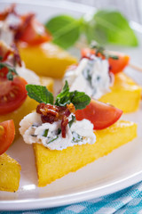 Polenta appetizers with ricotta and bacon