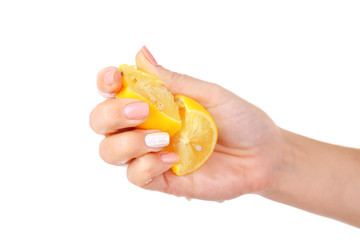 Female hand squeezing lemon isolated on white