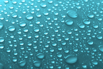 Water drops on glass on light background