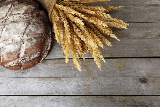 Bread with ears on wooden background