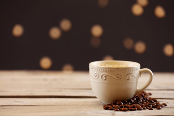 Cup of coffee on table on brown background