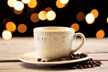 Cup of coffee on table on brown background
