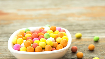 Colourful candy in ceramic bowl