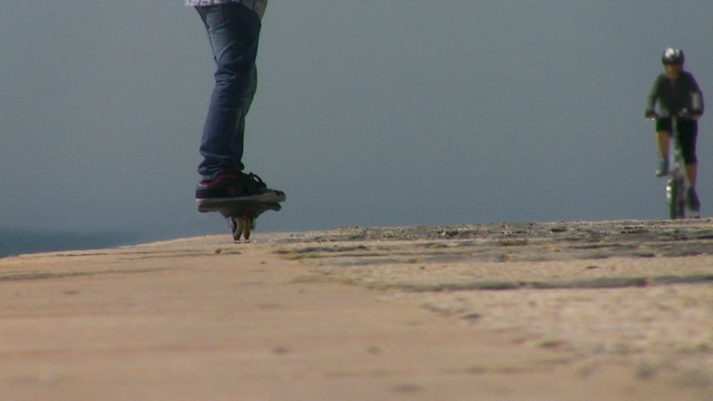 Kid riding caster board on sunny day