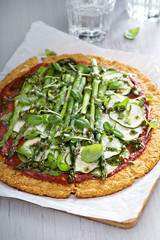 Cauliflower pizza with zucchini and asparagus