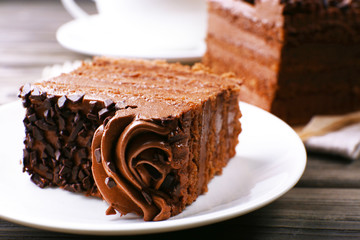Tasty pieces of chocolate cake on wooden table background