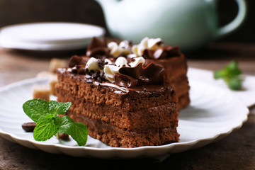 Tasty piece of chocolate cake with mint