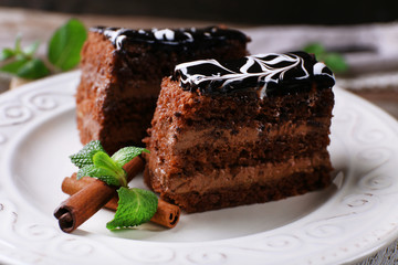 Tasty pieces of chocolate cake with mint and cinnamon