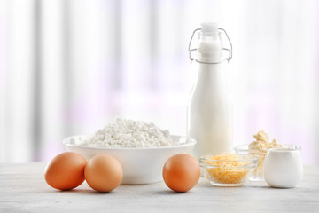 Different products on wooden table on curtain background