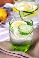 Fresh water with lemon and cucumber in glassware