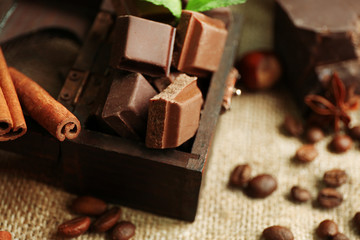 Still life with set of chocolate on burlap cloth, closeup