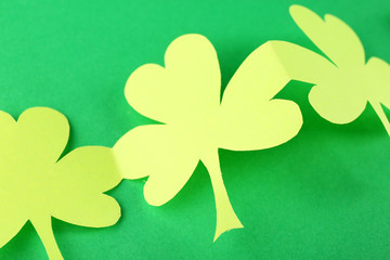 Shamrock leaves on green background