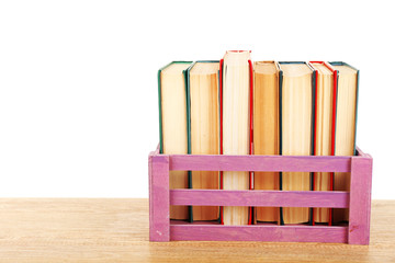 Books in wooden box isolated on white