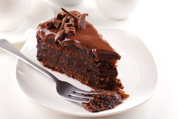 Fototapeta na wymiar Delicious chocolate cake on plate on table on light background