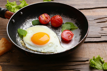 Bacon and eggs on rustic wooden planks background