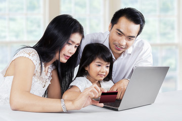 Family doing purchasing online at home
