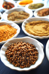 Different kinds of spices in ceramics spoons, close-up,