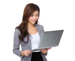 Young asian businesswoman look at notebook computer