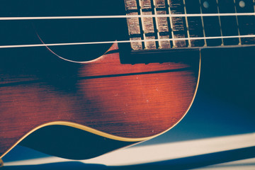 close up of line of Ukulele on the table with soft sun light