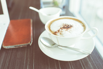 Coffee and mobile case in cafe.