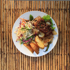 Khmer barracuda steak with vegetable salad