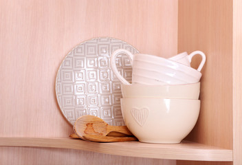 Tableware on wooden shelf