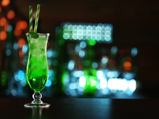 Green cocktail on table on dark background