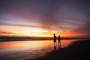 Fototapeta na wymiar Playful children on beach at sunset time
