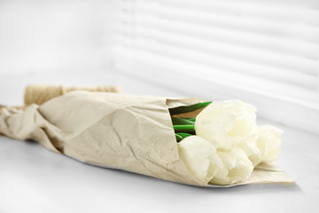 White beautiful tulips in light interior