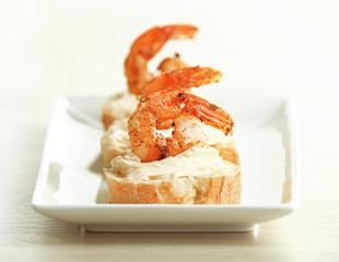 Appetizer canape with shrimp on plate on table close up