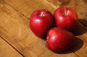 Fresh red apples on wooden background, Healthy fruit background.