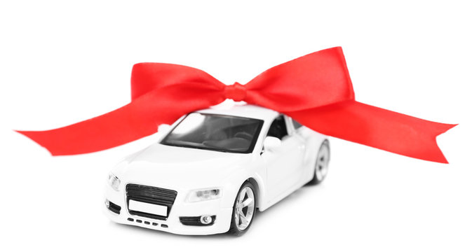 Car with red bow as present isolated on white