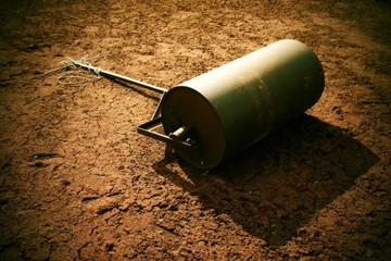 Old rusty iron barrel for maintenance of neglect tennis court.