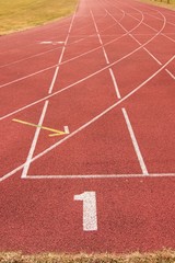 Fototapeta premium White lines and texture of running racetrack, red racetrack