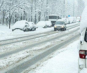 Snowy winter road with cars  in snow storm
