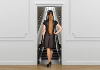 Girl standing back to doorway going on escalator