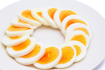 Sliced boiled egg arranged on a white plate