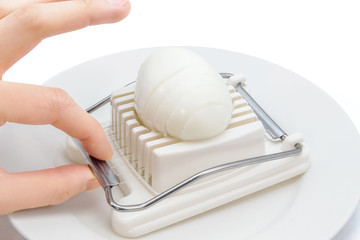 cutting an egg with an egg slicer