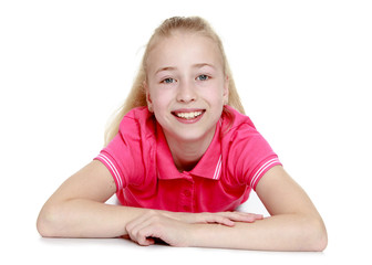 Positive blonde girl lying on the floor and looking directly at