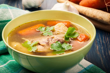 Chicken broth with noodles and carrot