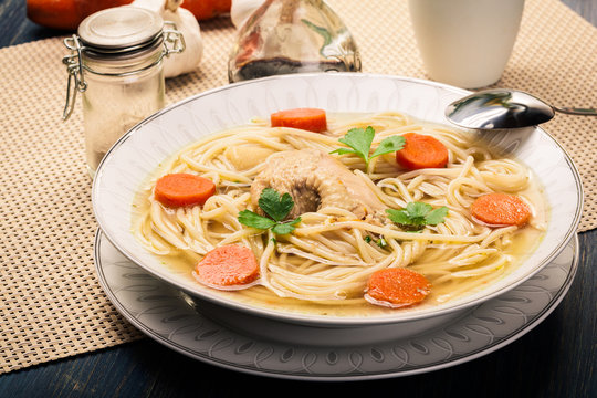 Chicken broth with noodles and carrot