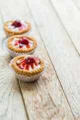 Three Strawberry tart on wooden floor