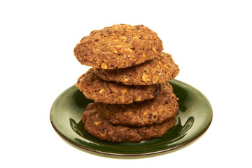 Biscuits isolated on a green plate on white background