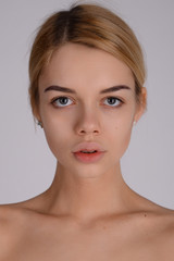 Close-up face portrait of young woman without make-up. Natural i